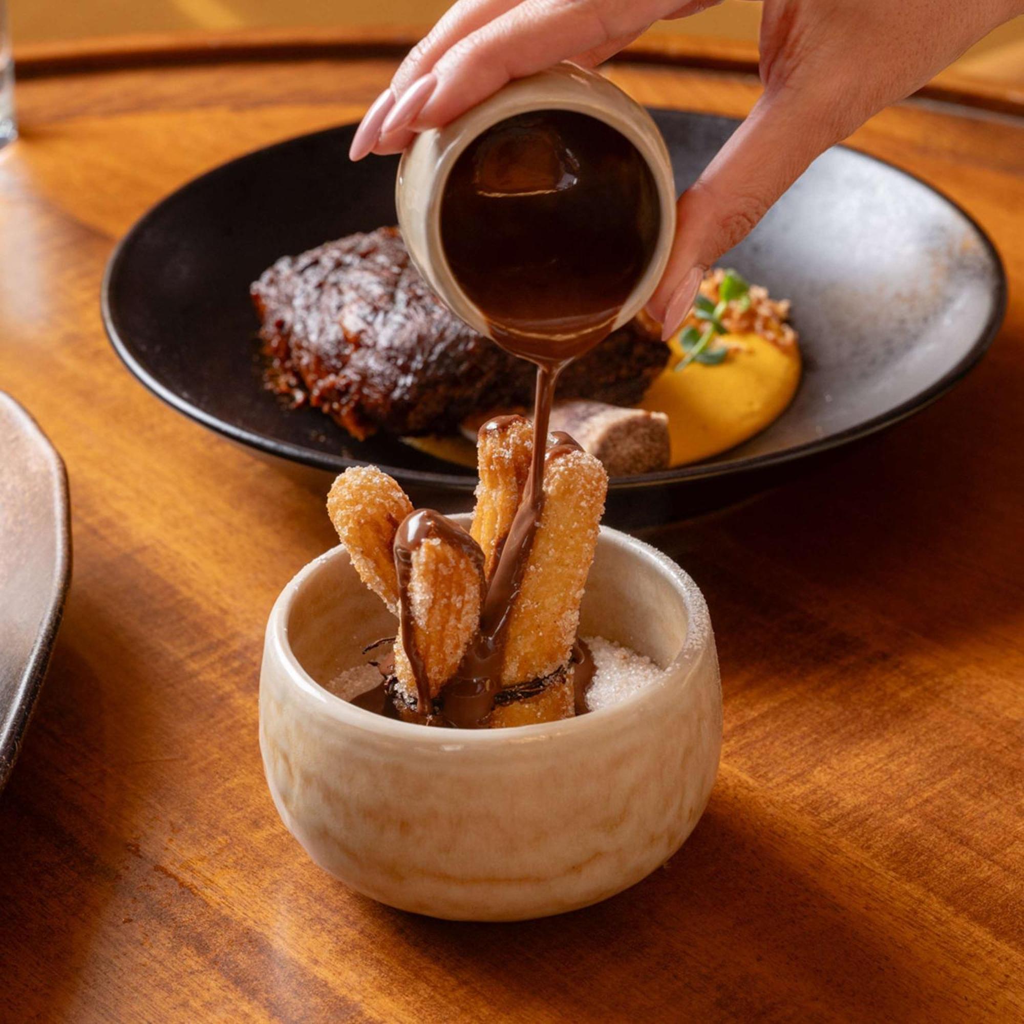 V Hotel Dubai, Curio Collection By Hilton Εξωτερικό φωτογραφία Soy sauce being poured on tempura